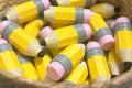 Yellow pencils with pink erasers in a woven basket