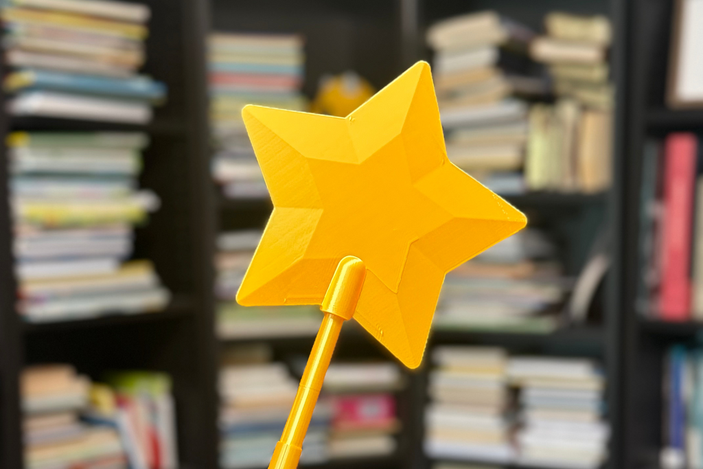 Yellow star-shaped wand held in front of a bookshelf filled with books