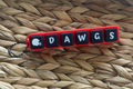 Keychain with 'DAWGS' letters on a woven surface