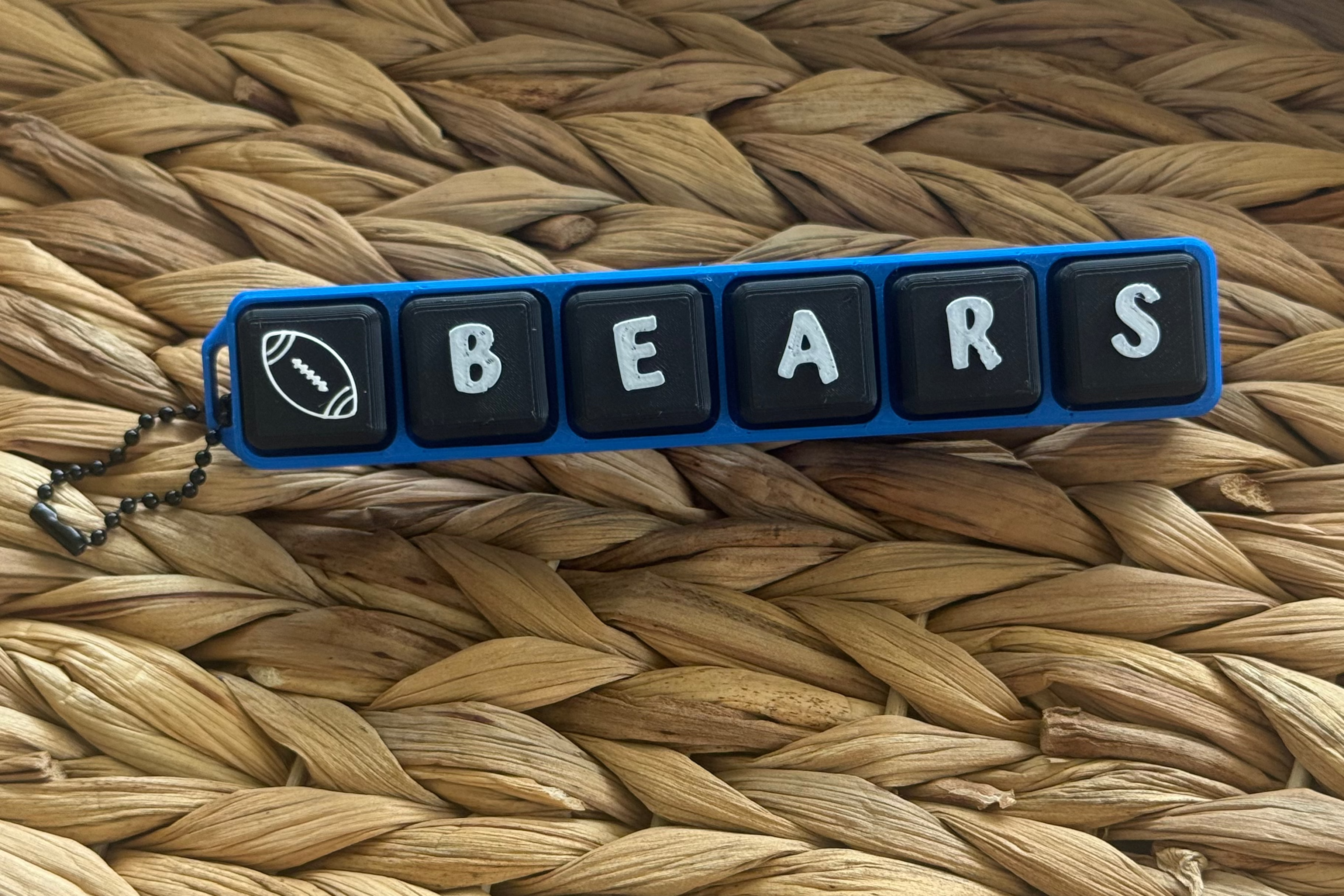 Keychain with 'BEARS' letters on a woven surface