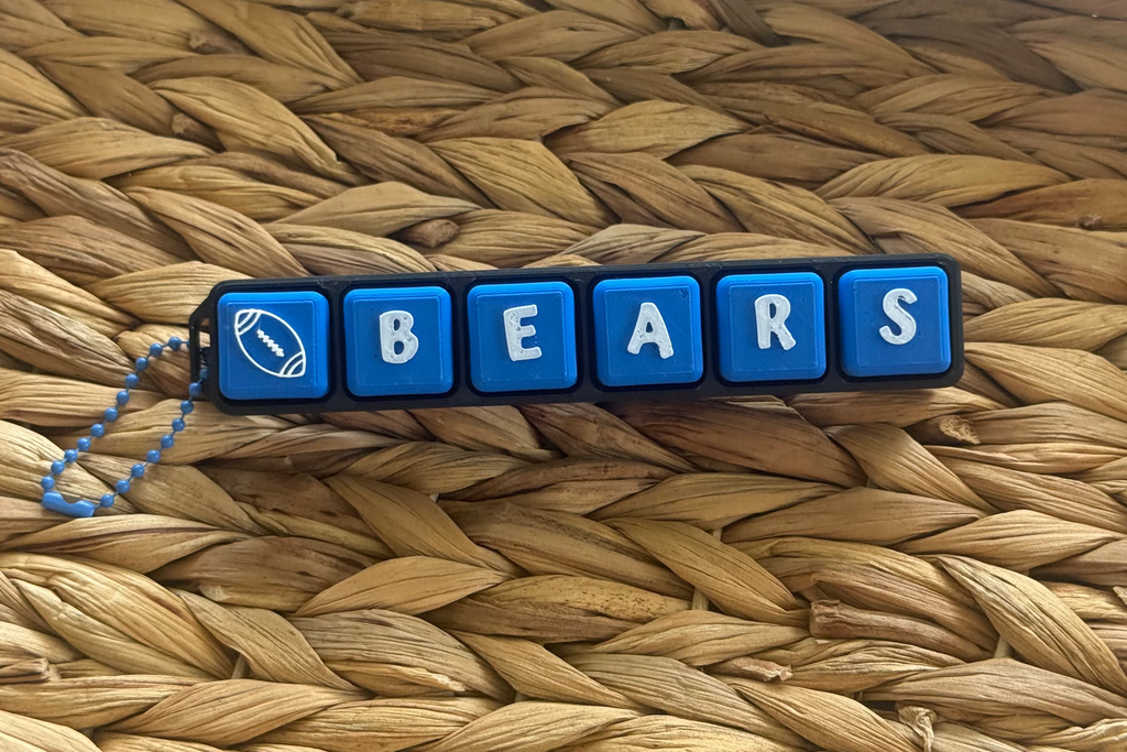Keychain with 'BEARS' letters on a woven surface