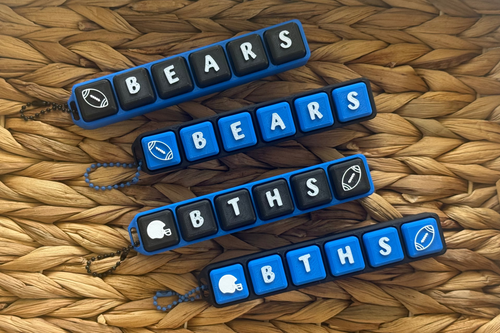 Keychains with text and graphics on a woven surface